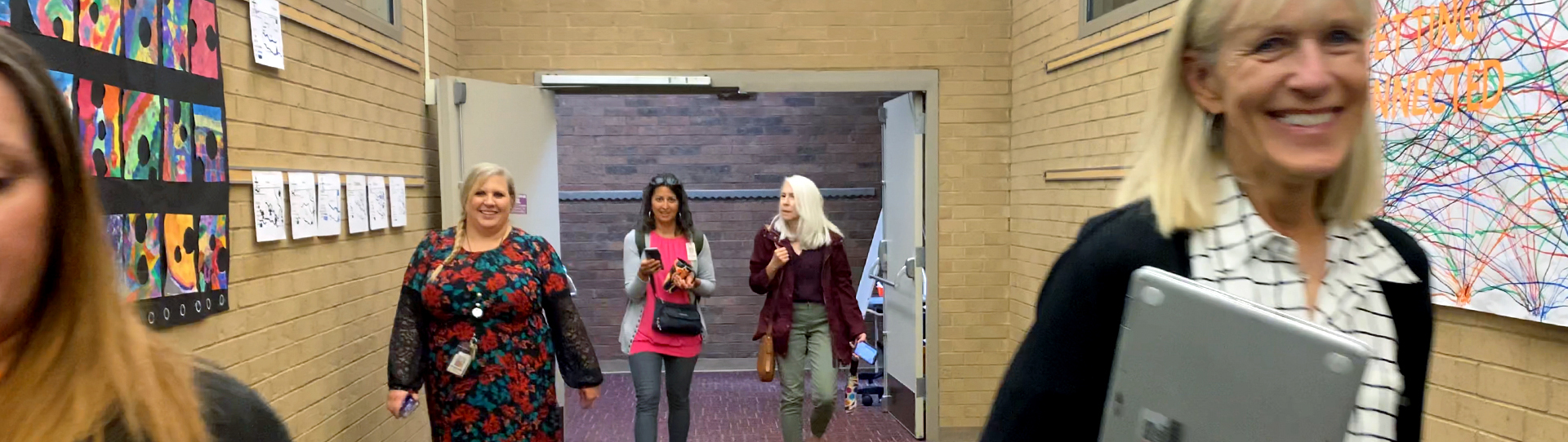 Image of the CITES team walking through a school hallway